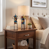 sculptures on nightstand beside bed lamp
