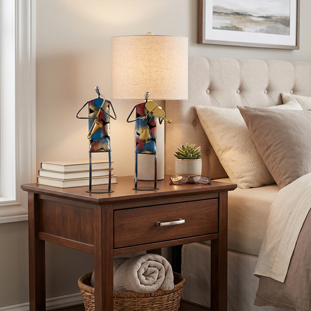 sculptures on nightstand beside bed lamp