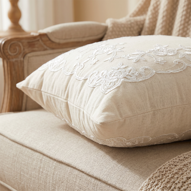 side profile of cream embroidered throw pillow