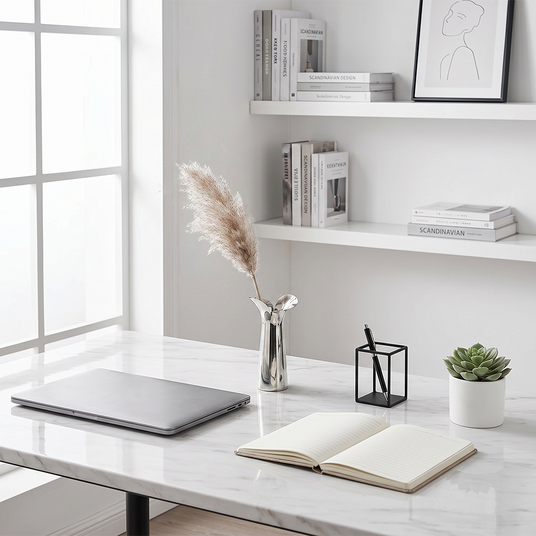 silver petal vase with pampas on desk