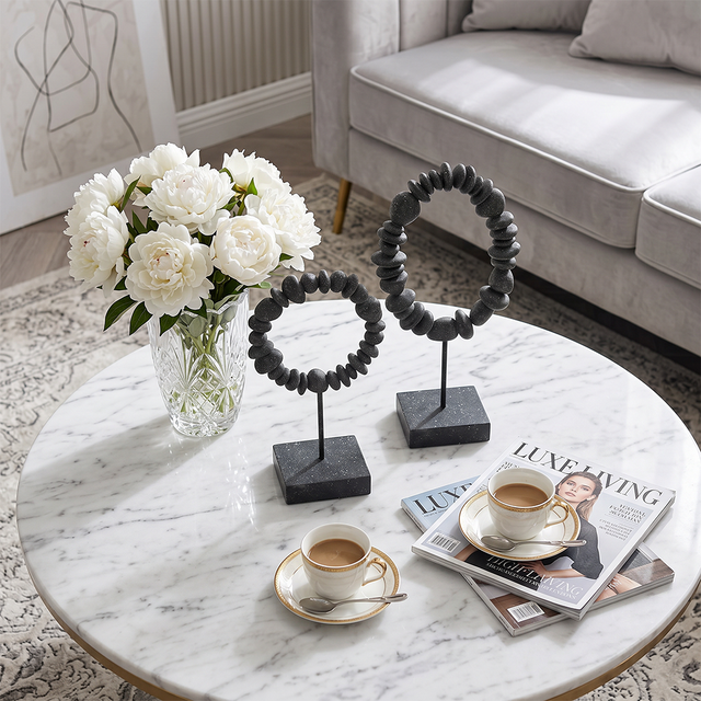 stone ring sculptures on marble table
