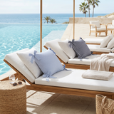 striped bow pillows on poolside lounge chairs