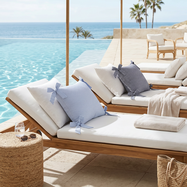 striped bow pillows on poolside lounge chairs