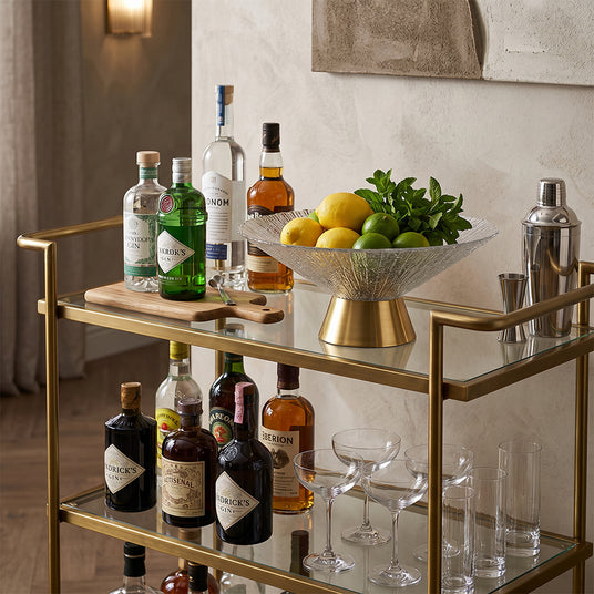 textured glass gold base fruit bowl with fruits on bar cart