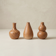 three brown ceramic vases front view