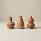 three brown ceramic vases front view