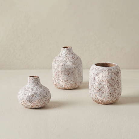 three textured vases on a flat surface