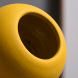top view of matte yellow spherical vase opening