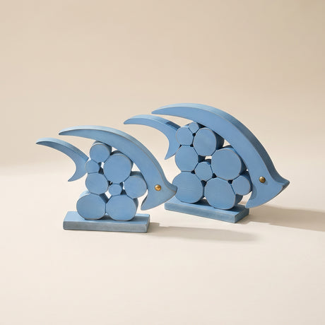 two blue wooden geometric dolphin figurines
