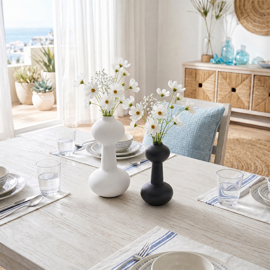 vases with daisies on white dining table