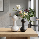 vases with flowers on wooden table