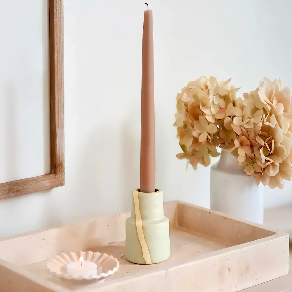 vintage ceramic bicolor decorative candle holders against the wall