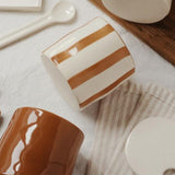 vintage-ceramic-hand-painted-spice-jars-set-with-spoon-wooden-tray-close-up-06102