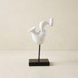 white abstract saxophone player sculpture on stand
