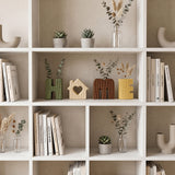 white bookshelf decor with letter vases and books
