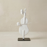 white cello player sculpture on black stand