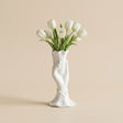 white ceramic hand vase with white tulips