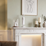 white figurine on marble fireplace mantel