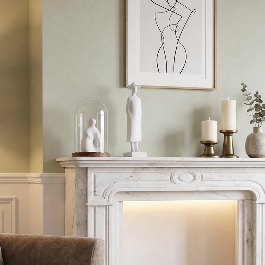 white figurine on marble fireplace mantel