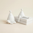 white figurines beside white books