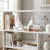 white figurines on white bookshelf