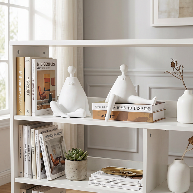 white figurines on white bookshelf