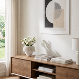 white loop vase with white flowers on wooden cabinet
