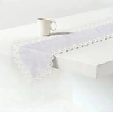 white satin lace table runner on the table