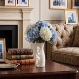 white vase with hydrangeas on table