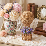 wicker balloon with flowers on lace romantic table