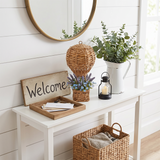 wicker hot air balloon on white entryway console