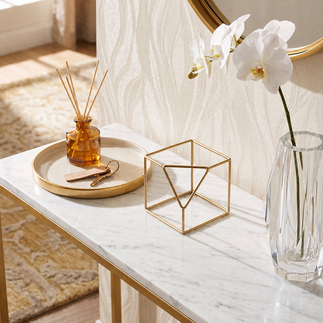 wire cube decor on marble desk
