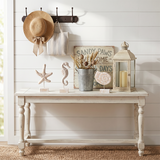 wood figurines on rustic white console table