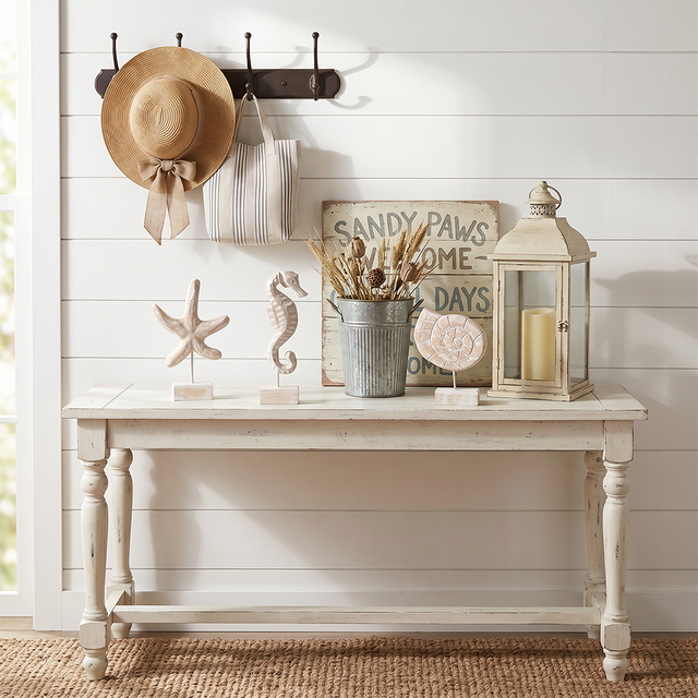 wood figurines on rustic white console table