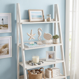 wood figurines on white leaning ladder shelf