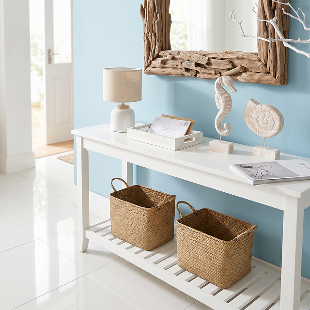 wood seahorse and seashell on entryway console
