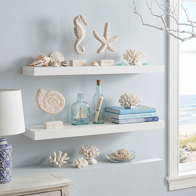 wood seahorse and starfish on white wall shelves