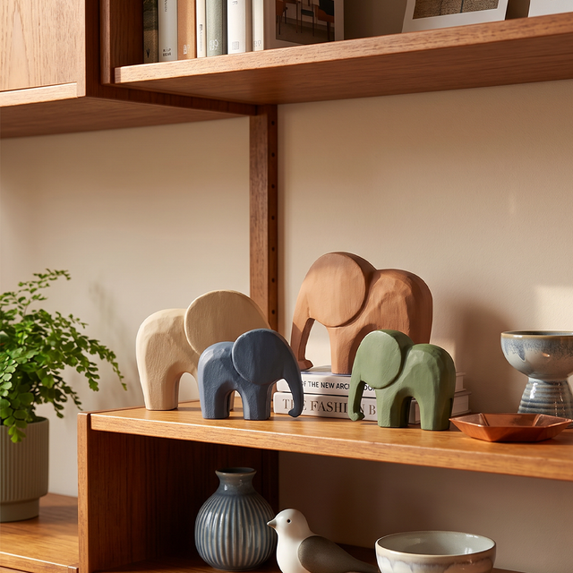 wooden elephants on wooden shelf with decor