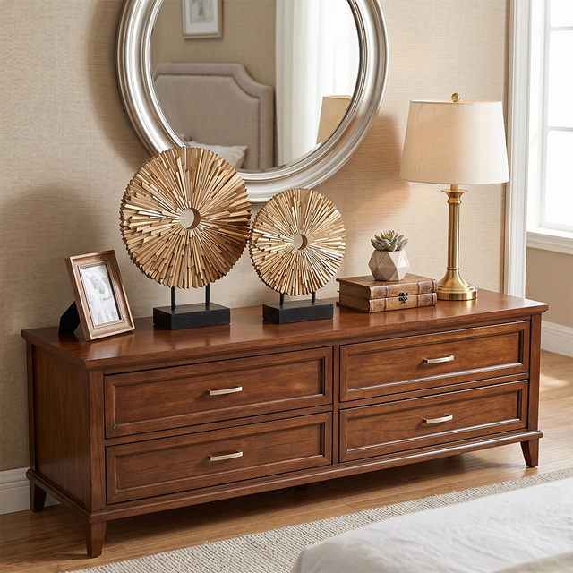 wooden sunburst sculptures on wooden dresser