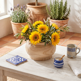 wooden vase with sunflowers on mediterranean table