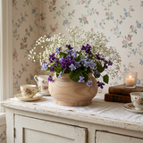 wooden vase with violets on vintage sideboard