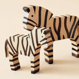 zebra sculpture on desk with books